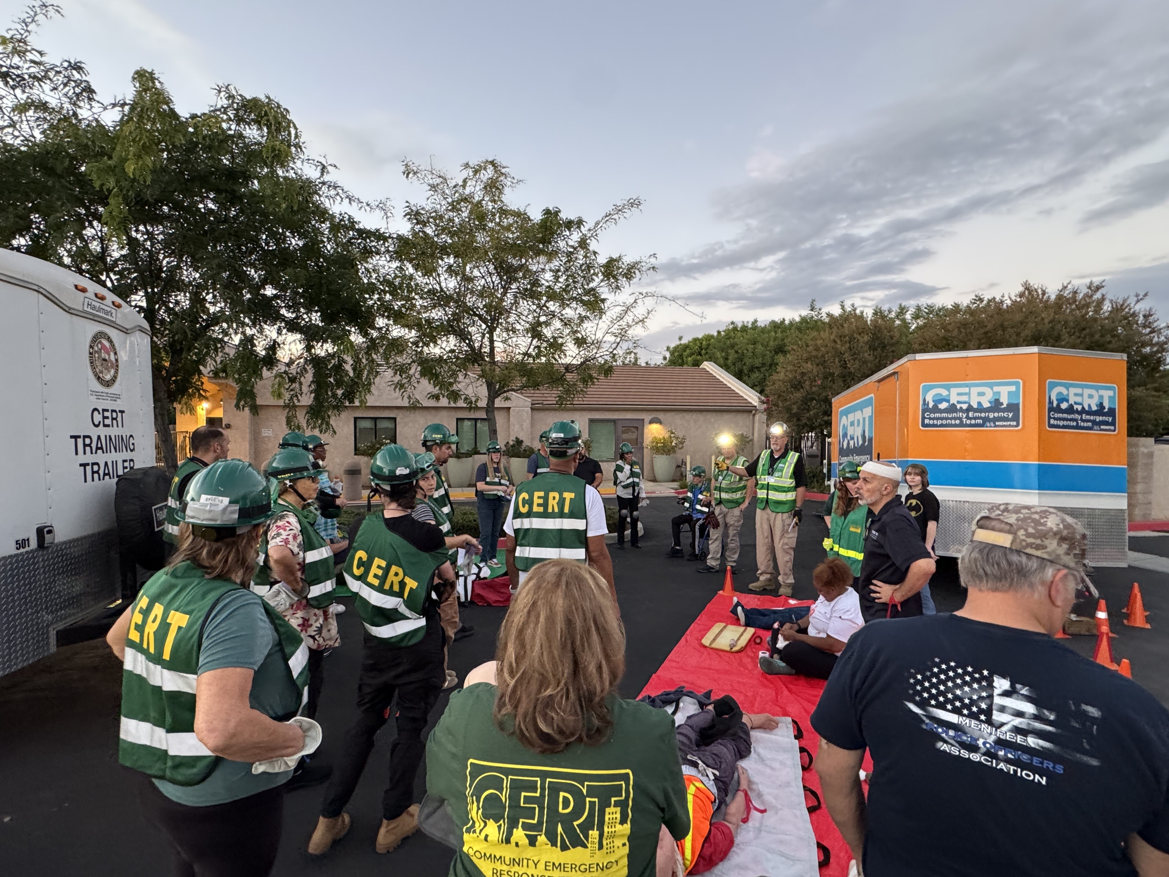 Menifee CERT volunteers gathered around a hands-on medical training exercise outdoors
