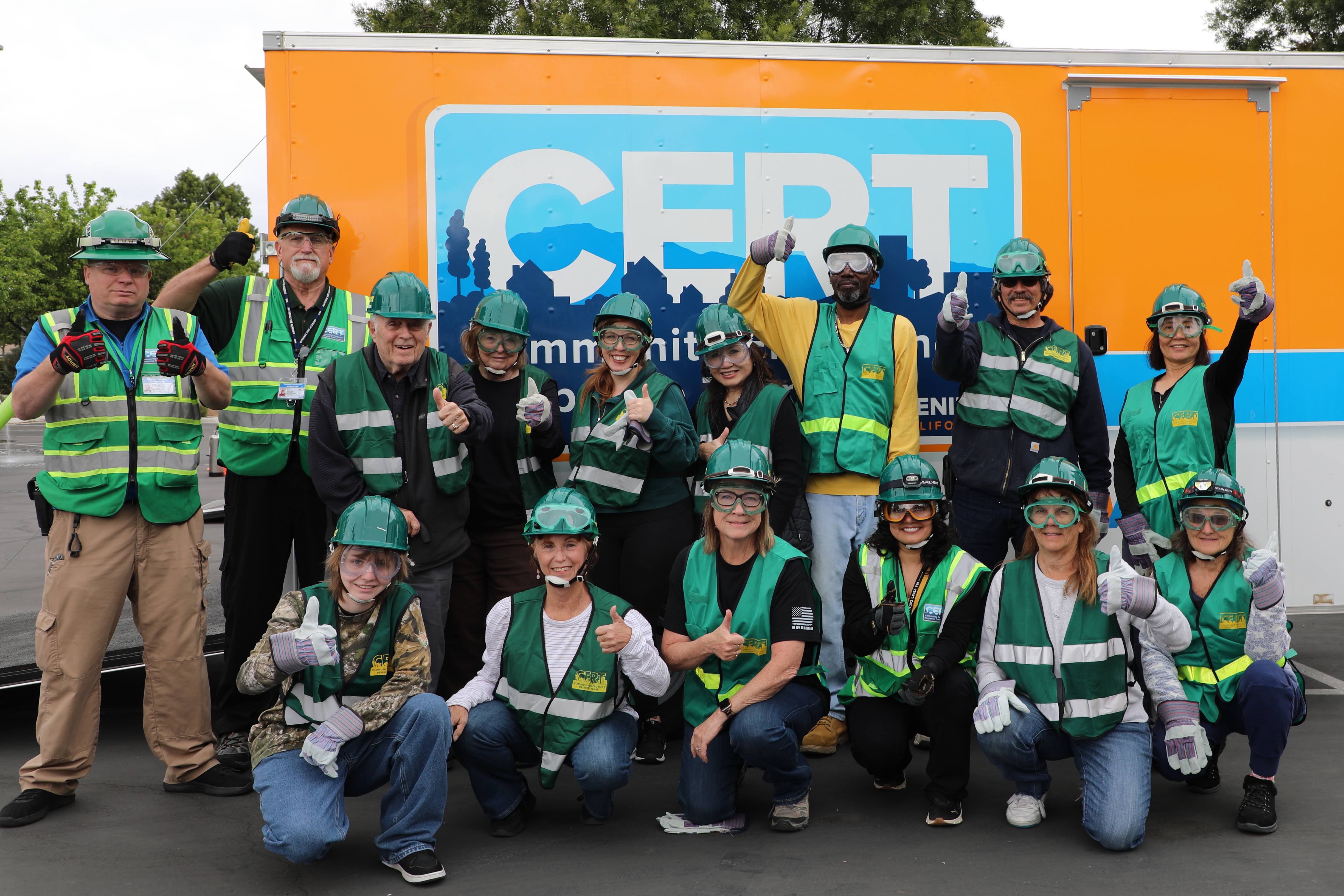 Menifee CERT members gathered in safety gear in front of the CERT training trailer